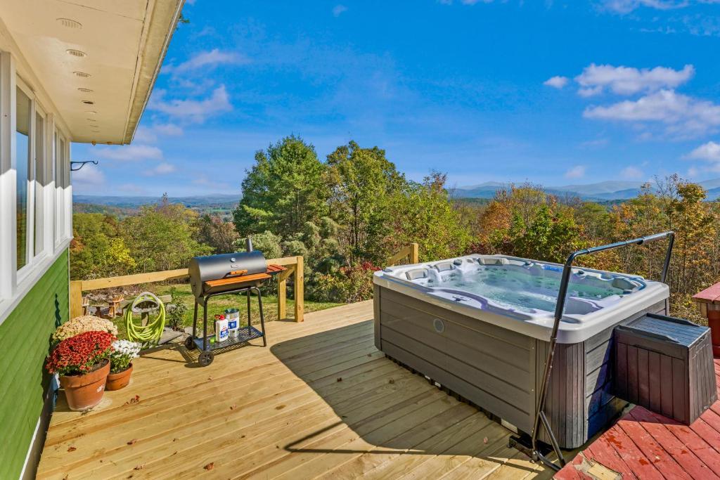 a hot tub on the deck of a house at Heritage Hollow in Cambridge