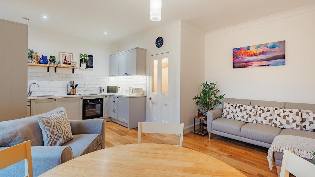 a living room with a couch and a table at The Wee Harbour Home in Anstruther