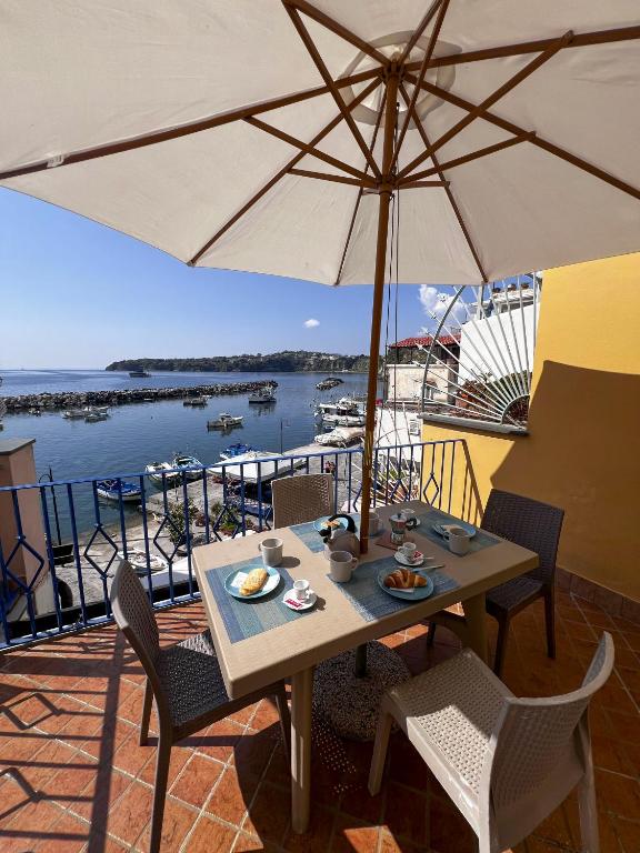 a table and chairs with an umbrella on a patio at Residence dei Pescatori in Procida