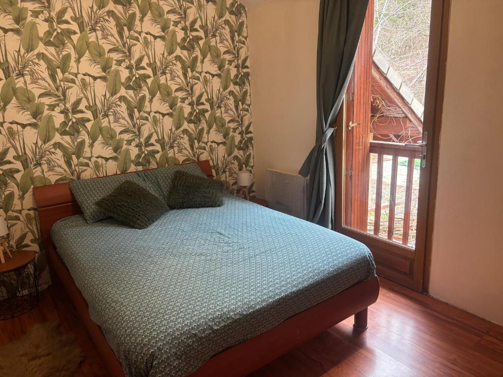 a small bed in a room with a window at Chambre Boscodon in Savines