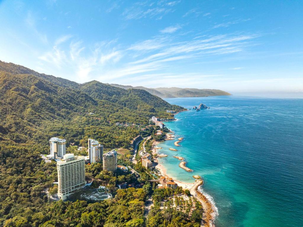 an aerial view of a beach with buildings and the ocean at Garza Blanca Sanctuary Puerto Vallarta in Puerto Vallarta