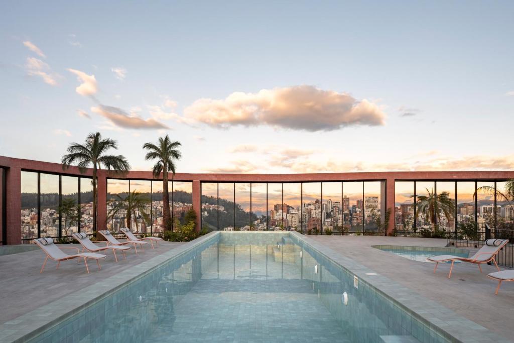 a swimming pool on the roof of a building with a view at Top Rentals EpiQ in Quito