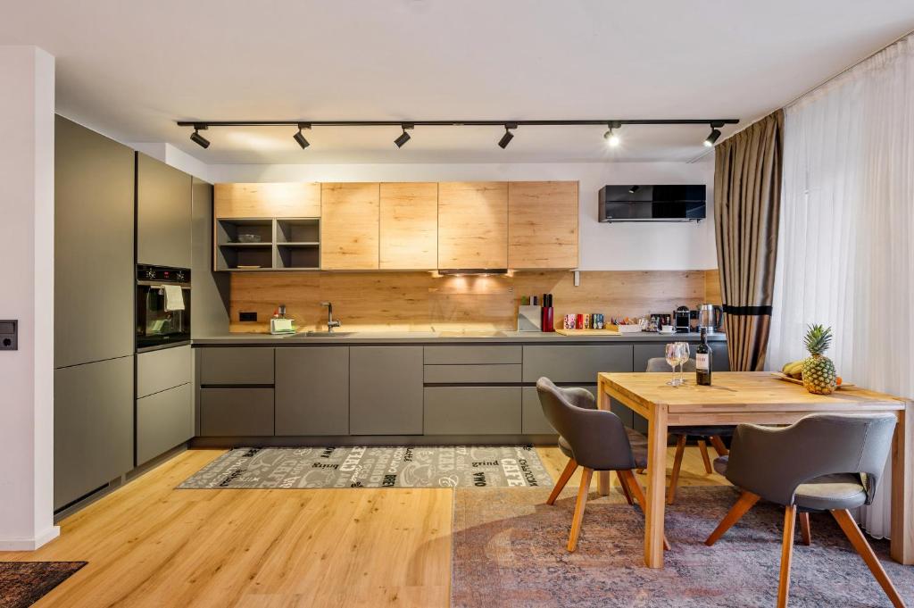 a kitchen with a wooden table and a dining room at Diamond Deluxe in Ludwigshafen am Rhein