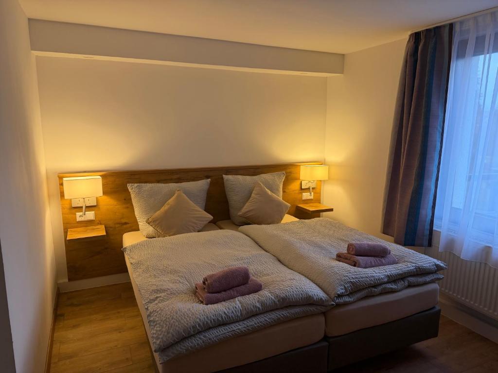 a bedroom with a bed with two pillows on it at Dionysos Traube in Rottweil