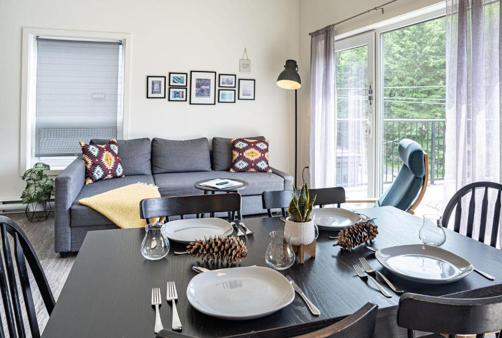 a living room with a table and a couch at The First Tracks Flat in Revelstoke