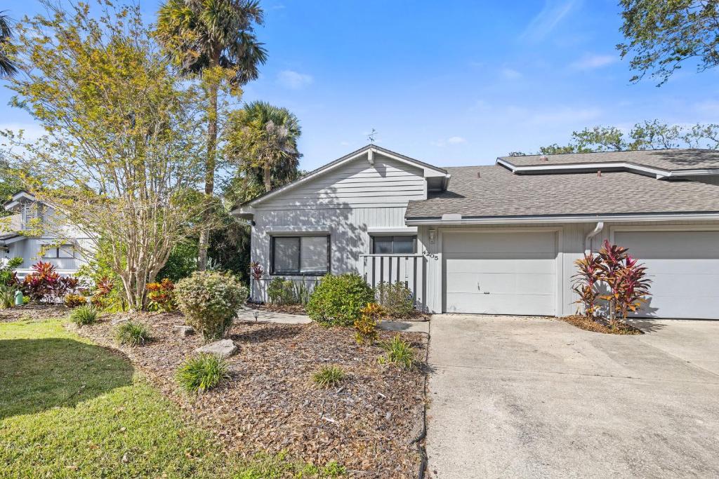 a house with a driveway and a garage at Sea Woods Home 4205 in New Smyrna Beach
