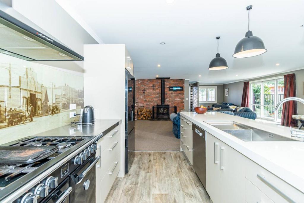 a kitchen with a sink and a stove top oven at Contemporary Methven Abode in Methven