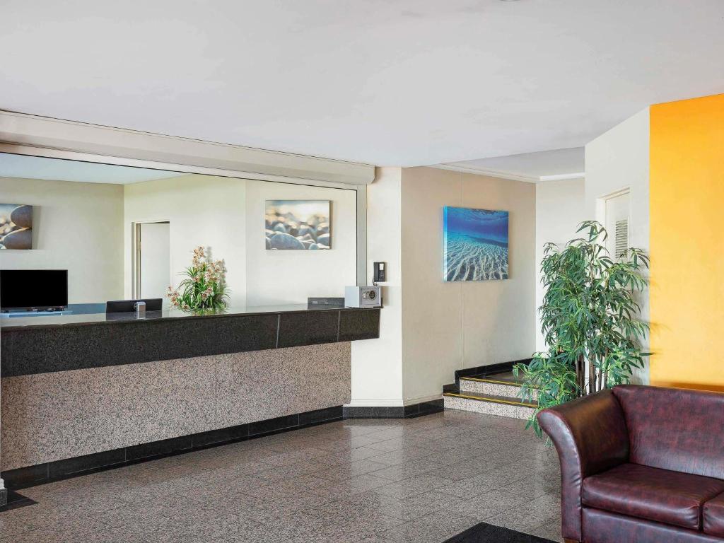 a lobby with a waiting room with a couch at BreakFree Imperial Surf in Gold Coast