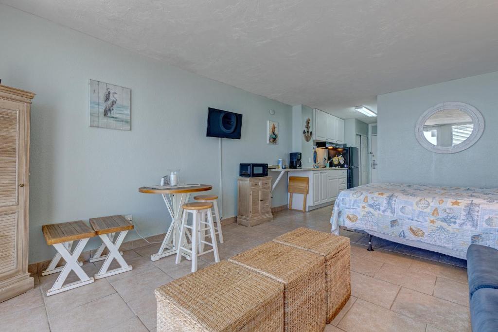 a bedroom with a bed and a table and a kitchen at The Ocean Calls Harbour Beach 612 in Daytona Beach
