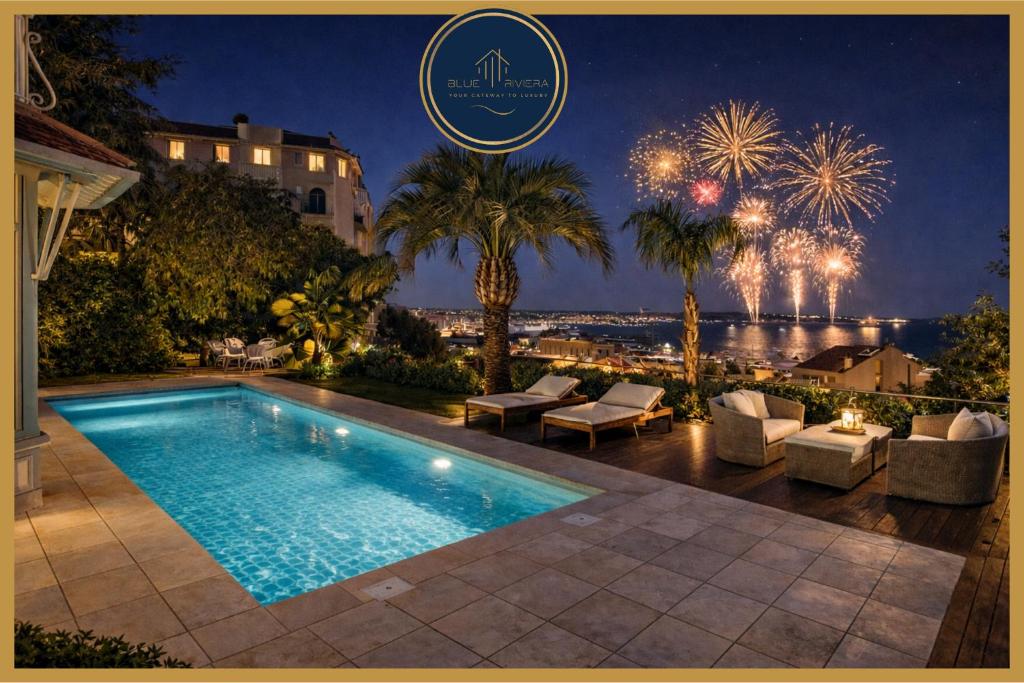 a villa with a swimming pool at night with fireworks at Villa Blue Riviera & Le Joyau de la baie de Cannes in Cannes
