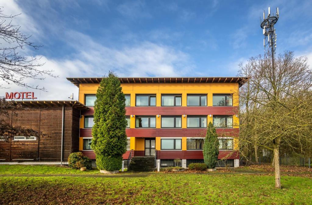 an orange building with a lot of windows at Raststättenhotel Tecklenburger Land West in Tecklenburg