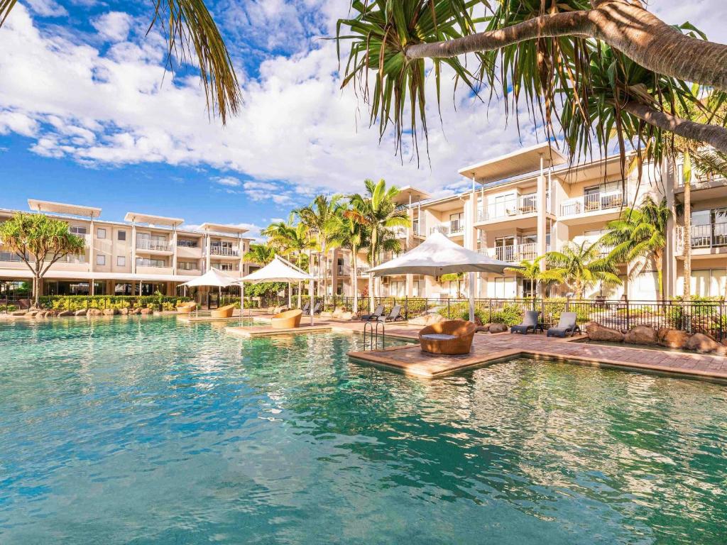 a swimming pool in front of a resort at Peppers Salt Resort & Spa in Kingscliff