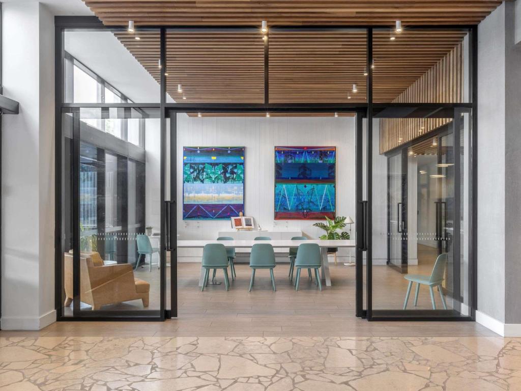 a dining room with a table and chairs at The Johnson Brisbane - Art Series in Brisbane