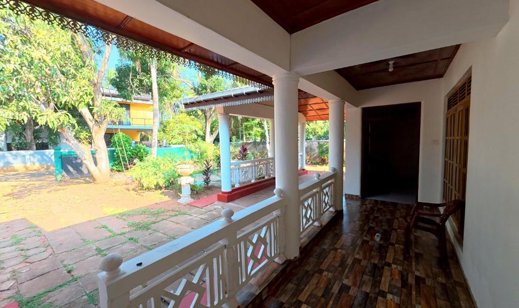 a porch of a house with a view of a yard at Diws Holiday Bungalow in Anuradhapura