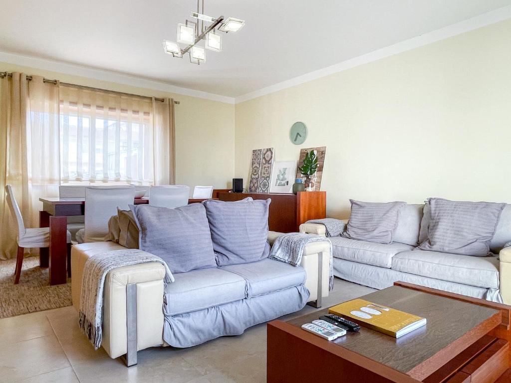 a living room with two couches and a table at Cozy & Calm Beach House in Ovar