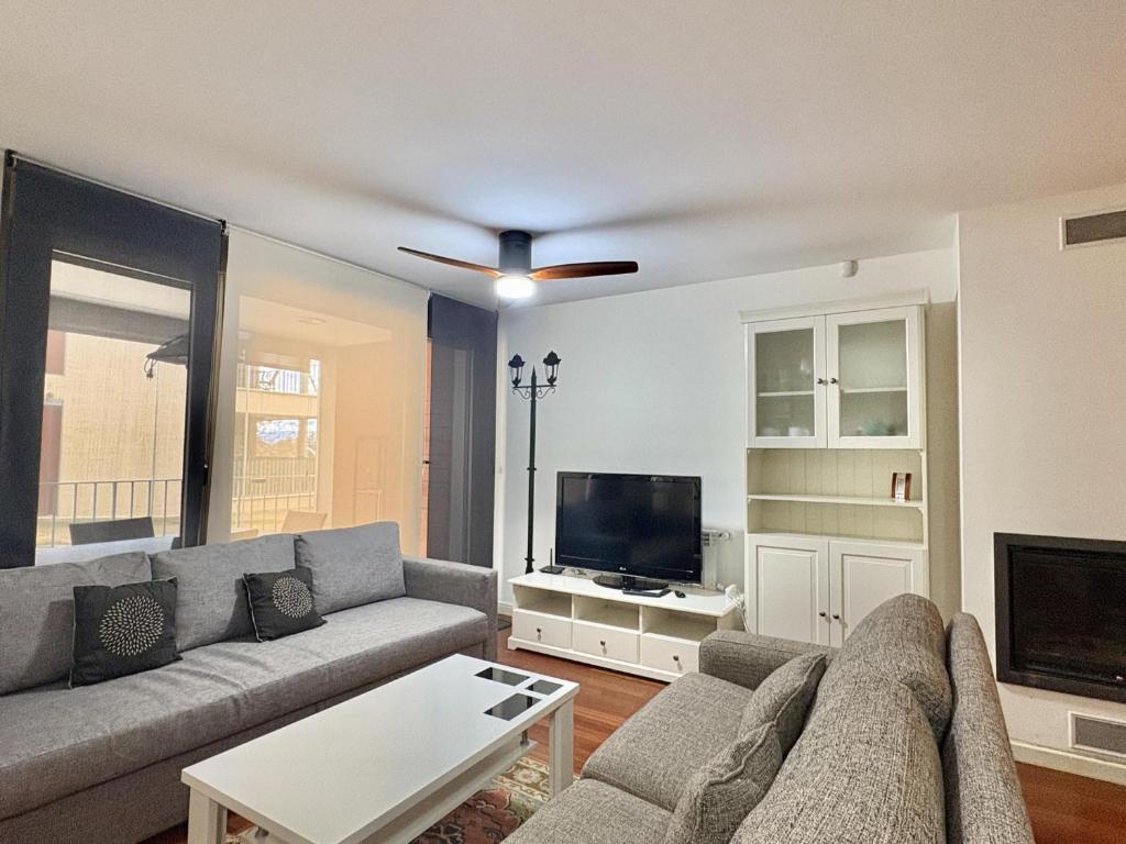 a living room with a couch and a flat screen tv at Terraza Varellas in Latas