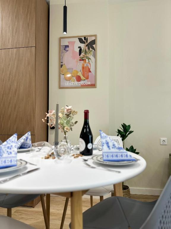 a white table with two chairs and a bottle of wine at Parkside Dighomi in Tbilisi City