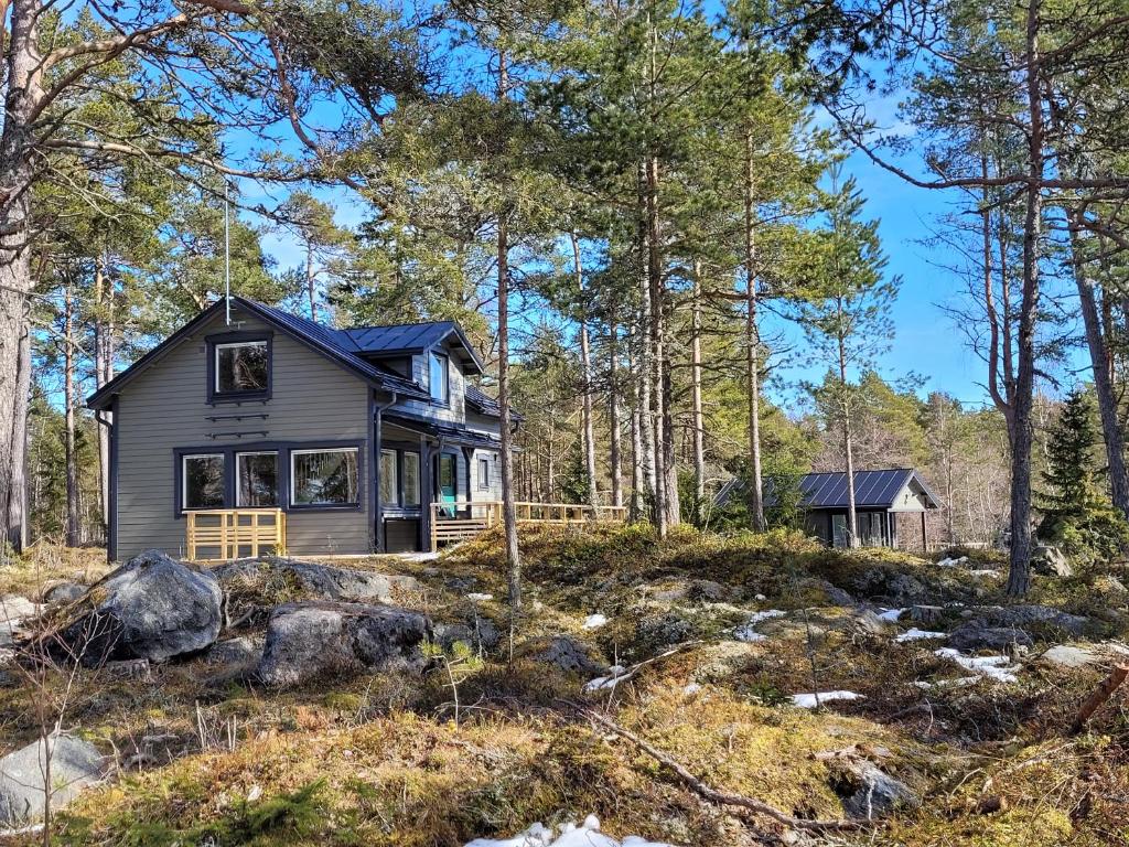 a small house in the woods with trees at Villa Furuviken in Kristinestad