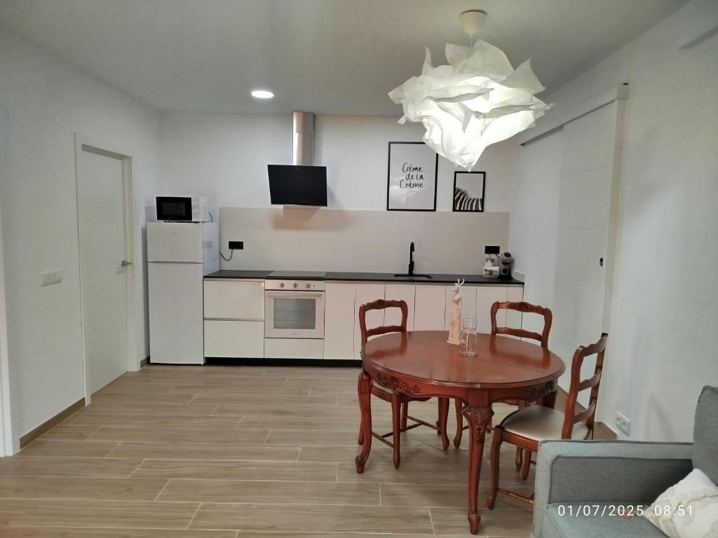 a kitchen and dining room with a table and chairs at Casa do Coto in Islote de Chilreu