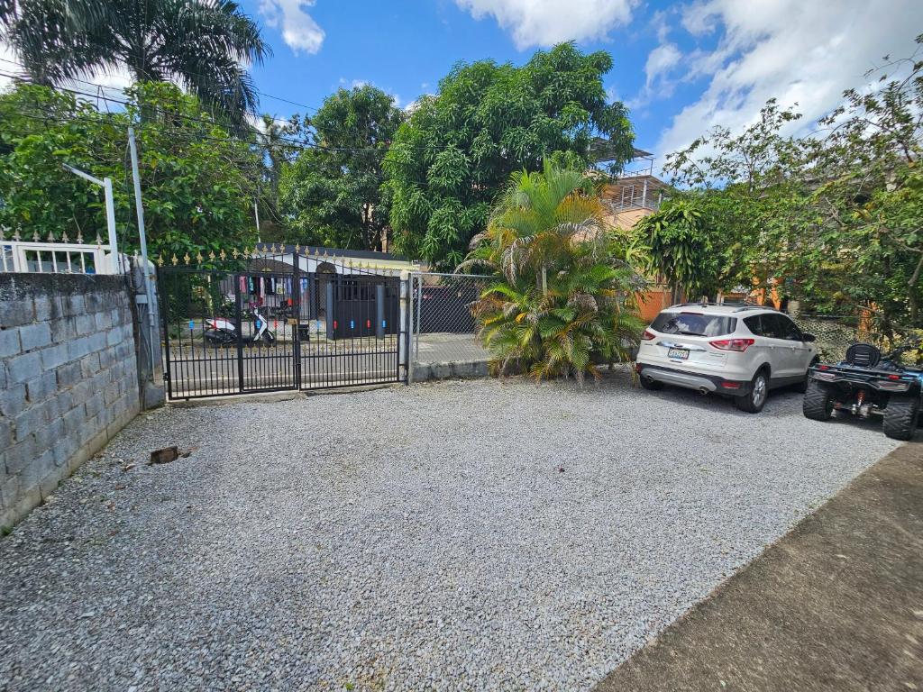 a car parked in a driveway next to a fence at Caribbean Domicil Apartment 02 in Las Terrenas