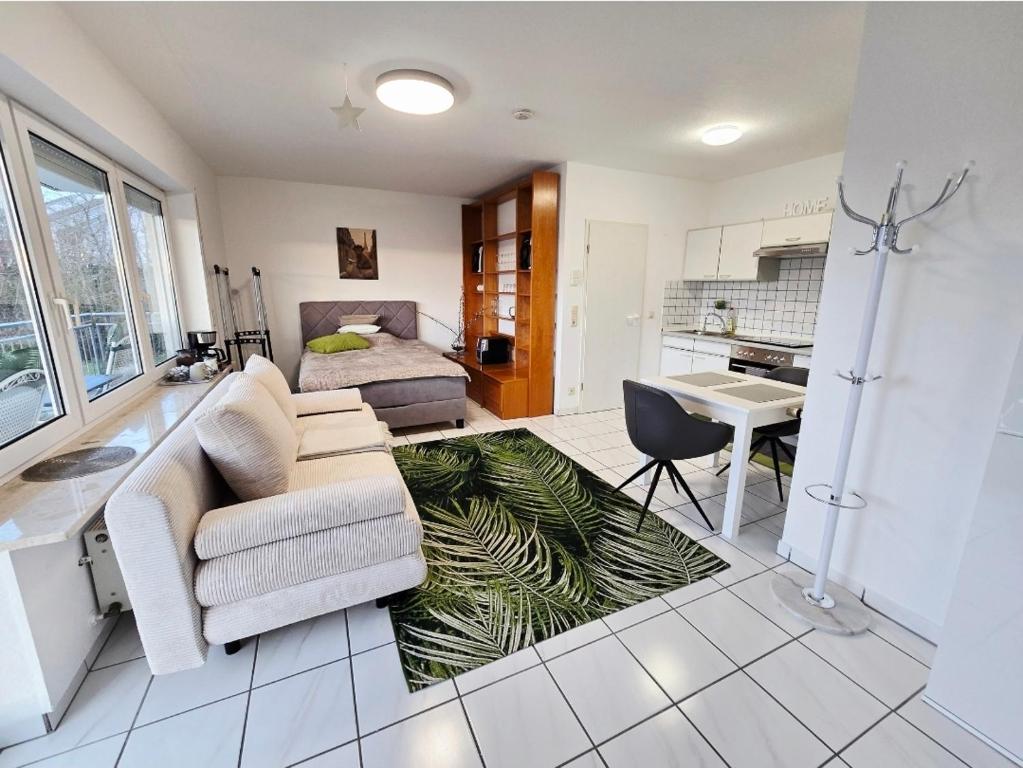 a living room with a couch and a palm tree rug at Apartment Kliniknähe in Idar-Oberstein