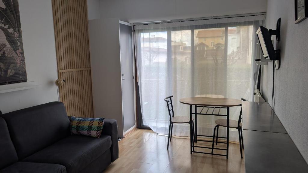 a living room with a couch and a table at T1 curistes et vacances in Dax