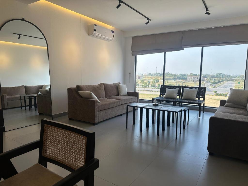 a living room with couches and a table at Oasis Living in Islamabad