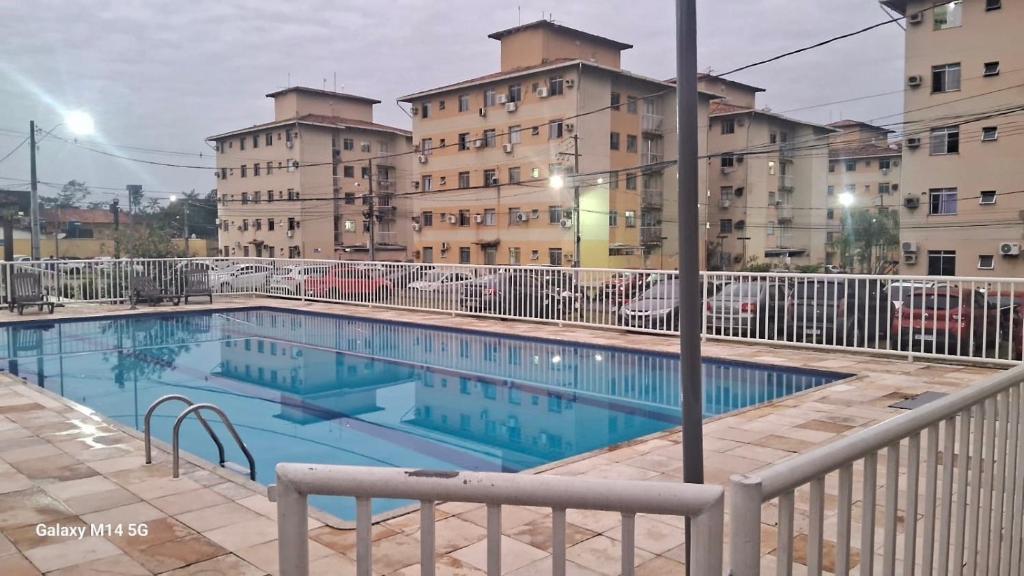 a swimming pool in front of some buildings at Lar Botticelli 2Quartos wifi piscina ArCond in Ananindeua