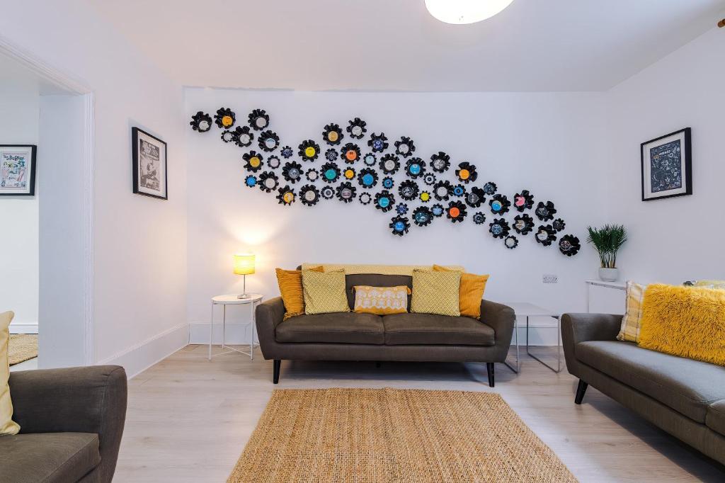 a living room with two couches and a wall at 15A Well Street in Ruthin