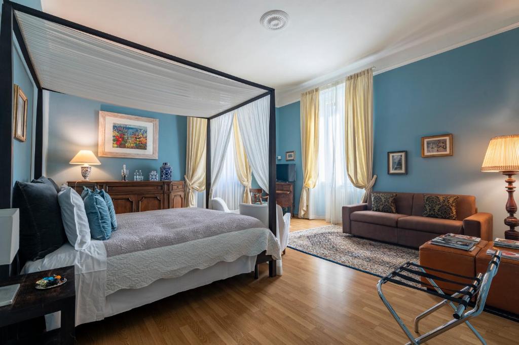 a bedroom with a bed and a living room at Opera Boutique B&B in Florence