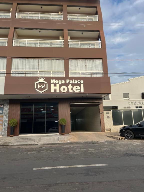 a hotel with a car parked in front of it at Mega Palace Hotel in Morrinhos