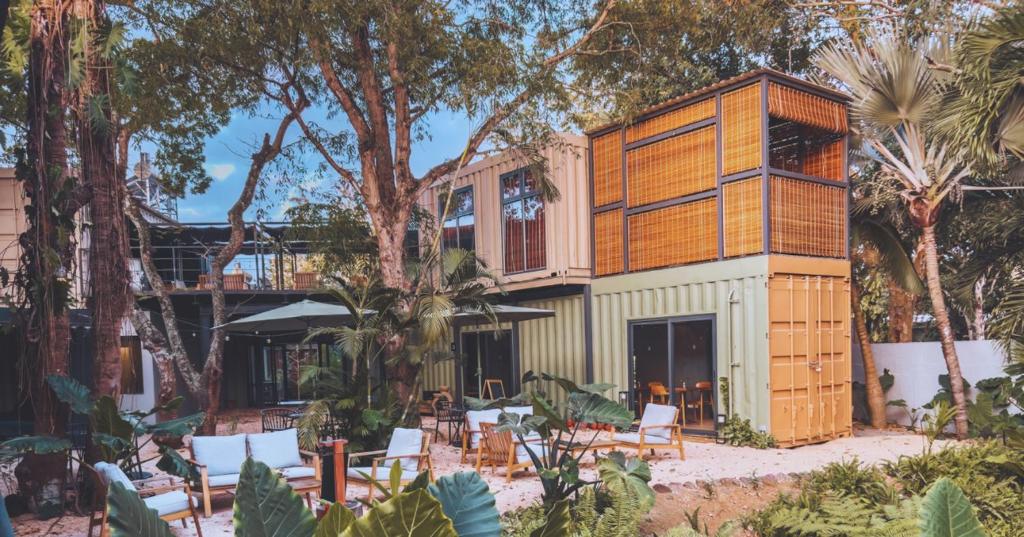 a house in the woods with chairs and trees at OBOĒ Gardenstē in Pereybere