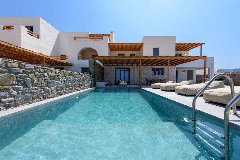 a swimming pool in front of a villa at Aegean Gem Villa in Mármara