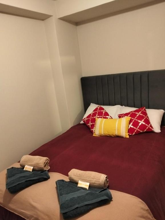 a bed with two towels sitting on top of it at Killitas home&apart in Cusco