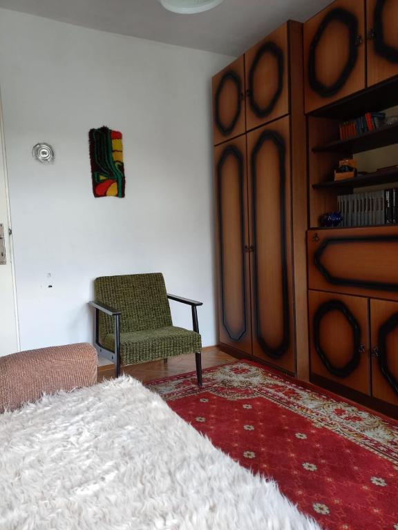 a living room with a bed and a chair at Domaćinstvo Simović in Duboko