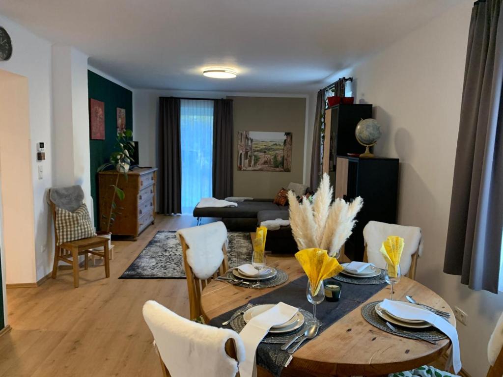 a living room with a wooden table and chairs at Ferienhaus Krenn in Bad Gleichenberg