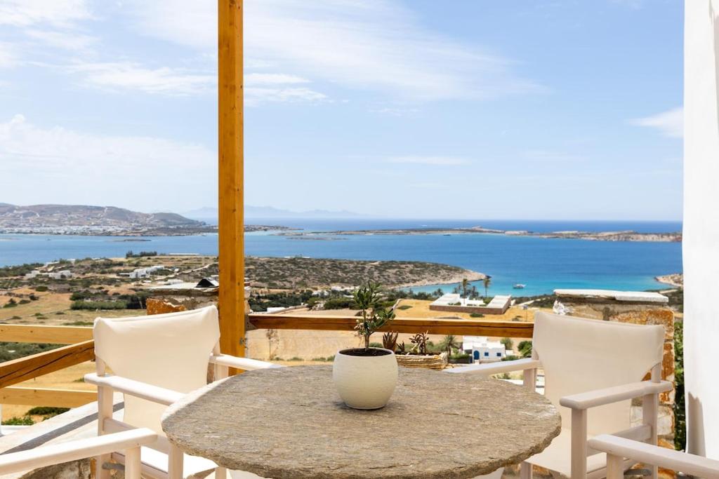 a table and chairs with a view of the ocean at Sarris Village Luxury 2 in Sarakíniko