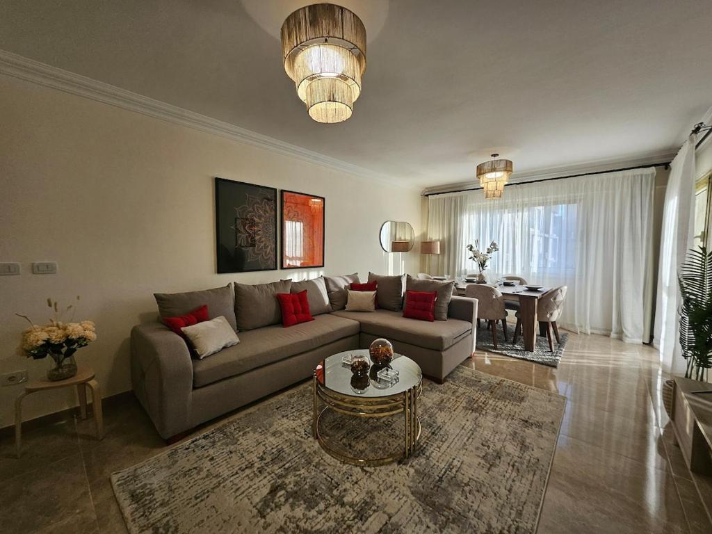 a living room with a couch and a table at Elite 3 BR Apartment in Zayed in Sheikh Zayed