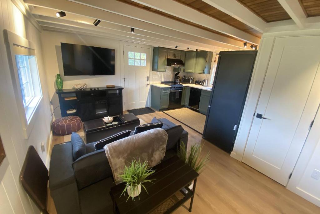 a living room with a couch and a kitchen at Cozy Coastal Cabin in Rockaway Beach