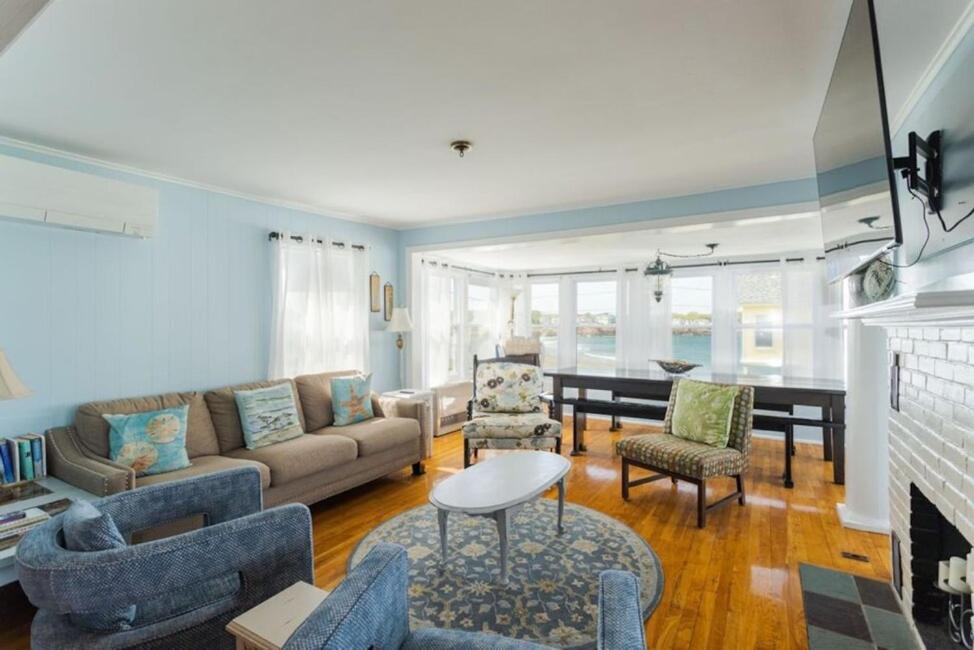a living room with a couch and a fireplace at Oceanfront Cottage - Steps from Short Sands Beach! in York