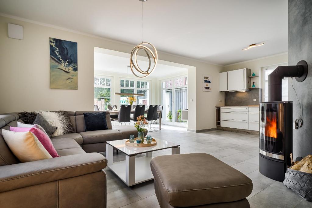 a living room with a couch and a fireplace at Strandzeit in Prerow