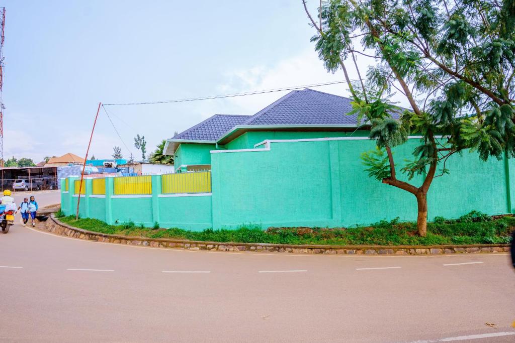 a blue building on the side of a street at Antoine in Taba