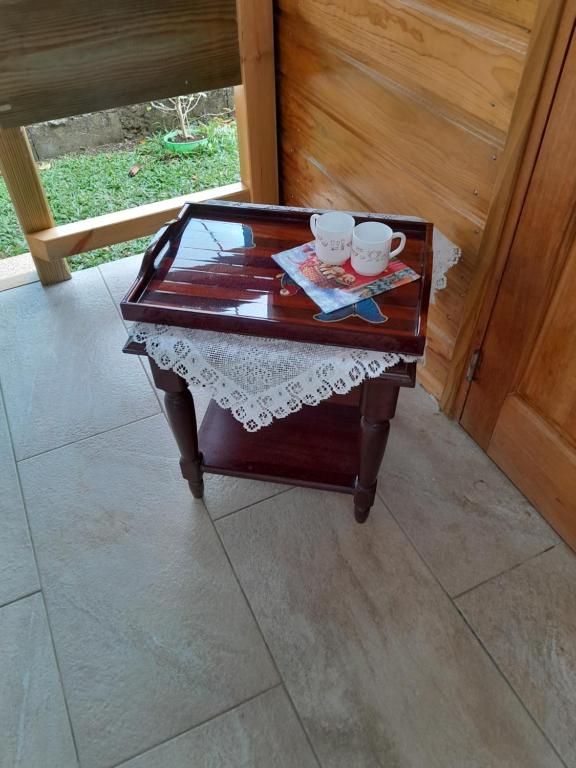 a coffee table with two cups on top of it at Studio LAVANDES in Lamentin