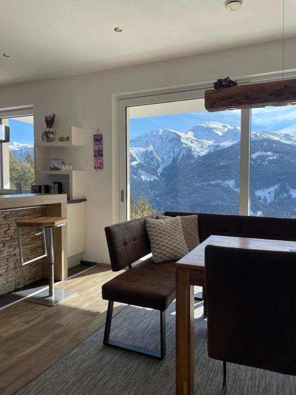 a living room with a couch and a table at Ferienhaus Hubertus Tirol 1-8 Personen in Pill