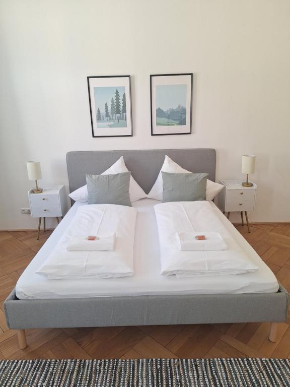 a large bed with two white pillows on it at Innsbruck Residence in Innsbruck