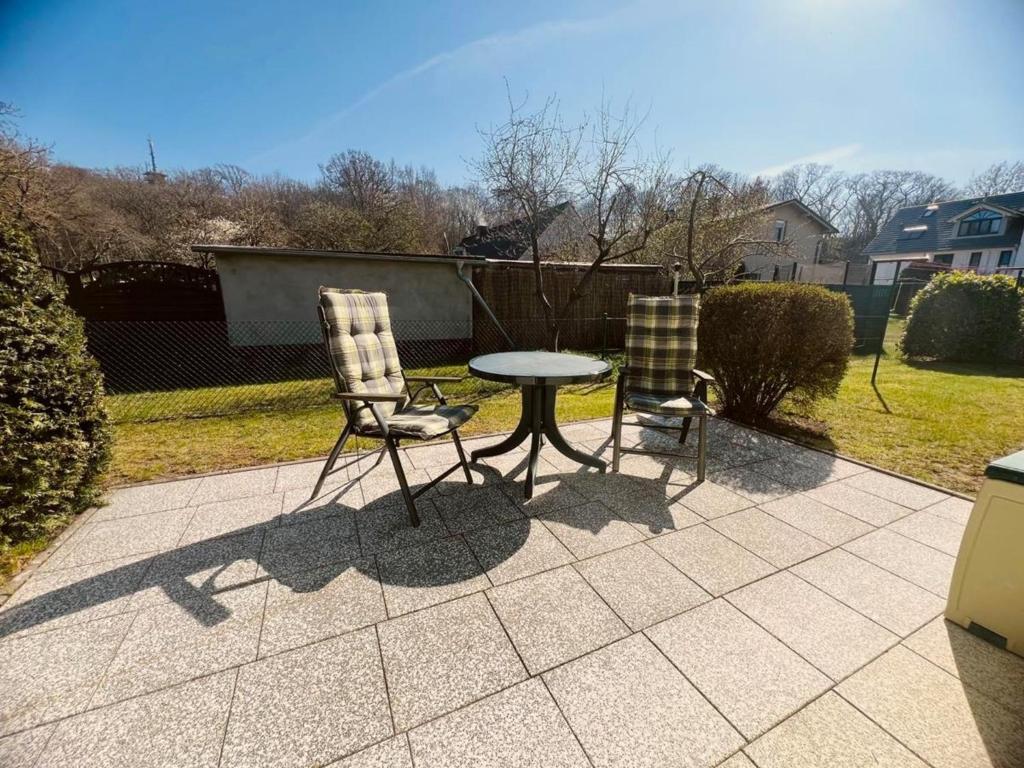 two chairs and a table on a patio at Ferienwohnung Bobtail in Thiessow