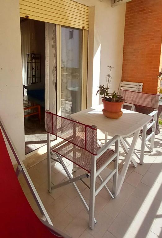 a white table and chairs on a patio at Al Centro - Gaeta in Gaeta