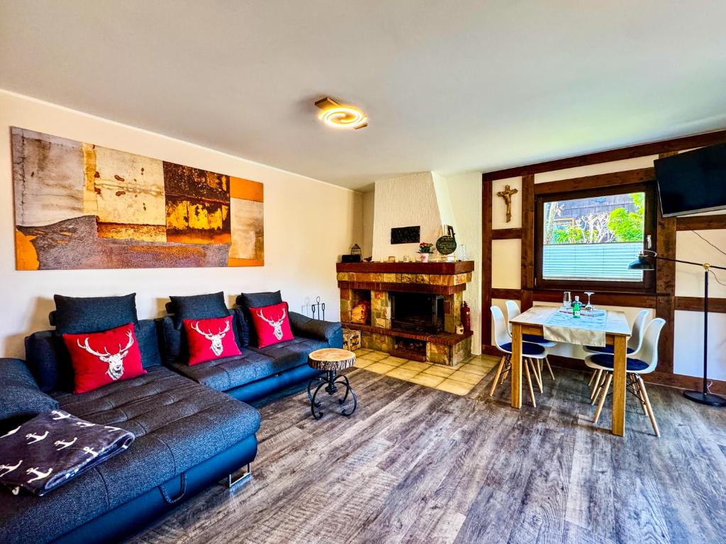 a living room with a couch and a table at Räuberlager 15 in Dammbach