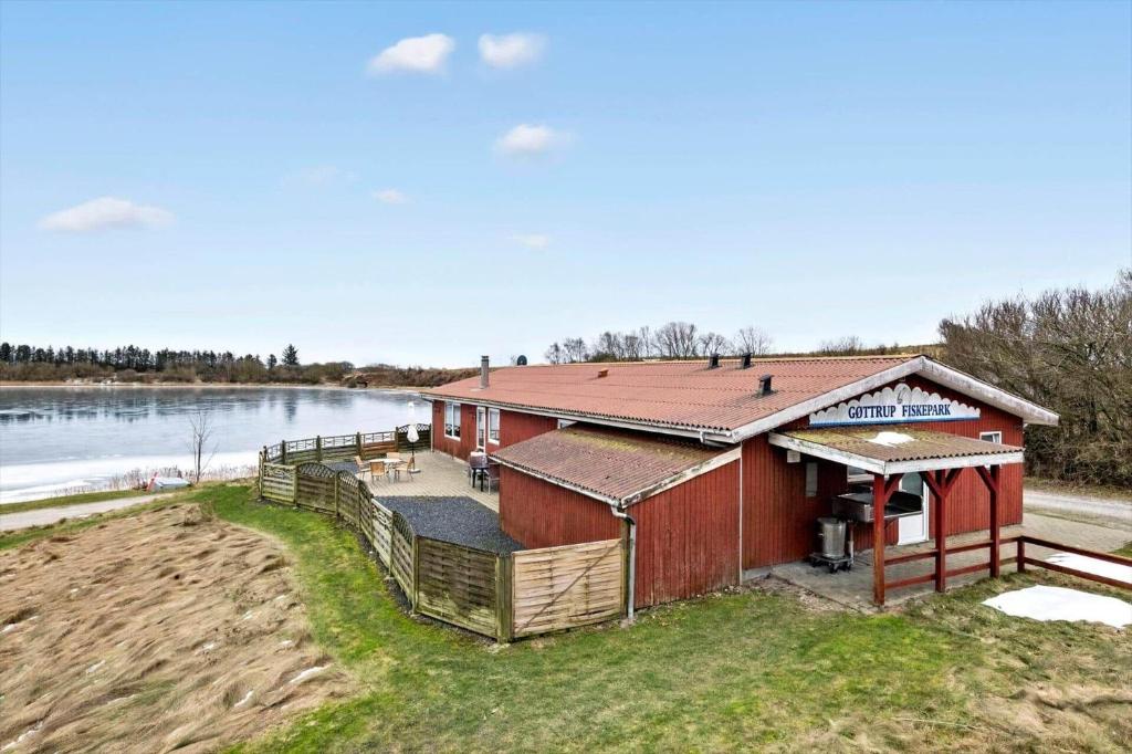 a house with a deck next to a river at JB380-Fjerritslev-Gottrupvej-311-C in Fjerritslev