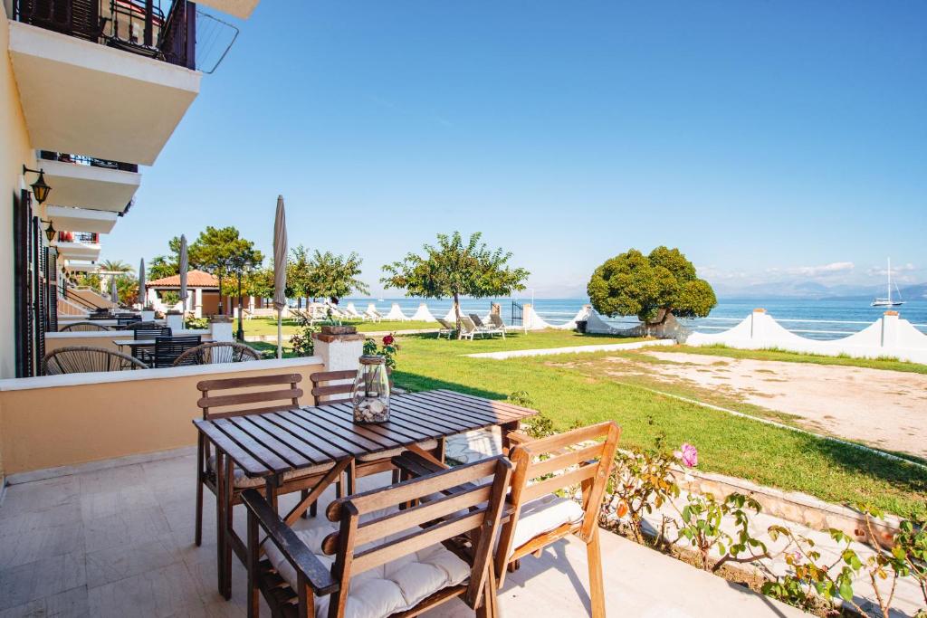 a table and chairs on a patio with a view of the ocean at Thalassa Apartments & Studios in Kavos